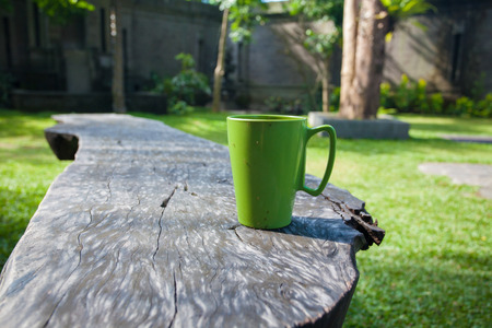 green coffee cup on wood table の写真素材