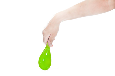 Hand of man catching a green bowl on a white background 