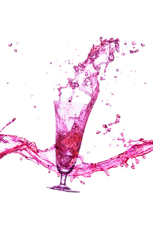 purple beverage splash out of the glass の写真素材