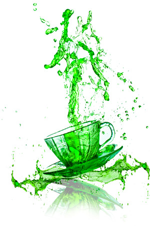 green beverage splash out of the glass の写真素材