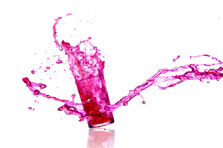 purple beverage splash out of the glass の写真素材