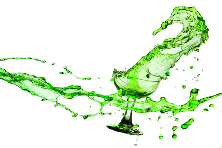 green water splash from glass on white background.の写真素材