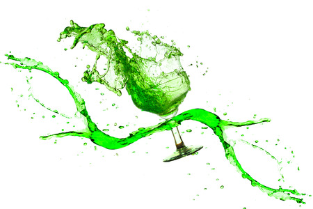 green water splash from glass on white background.の写真素材
