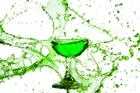 green water splash from glass on white background.の写真素材