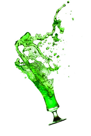 green water splash from glass on white background.の写真素材