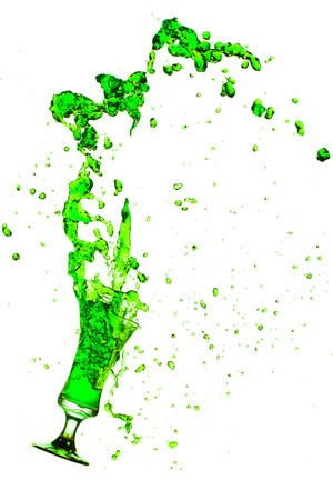 Drink green splash out of glass on a white background.の写真素材