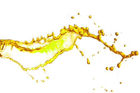 Drinks yellow splash out of glass.の写真素材