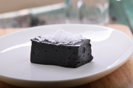 Black sweet coconut on a plateの写真素材