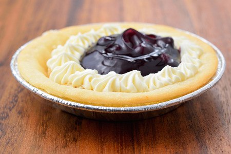 Blueberry pie and berries on rustic wooden tableの写真素材