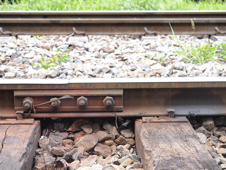 Tinted metal screw on railway track