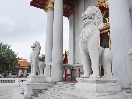 A pair of Singhs (Lions), protection symbol, at the front of the Marble Temple (Wat Benjamabophit), Bangkok, Thailandの写真素材