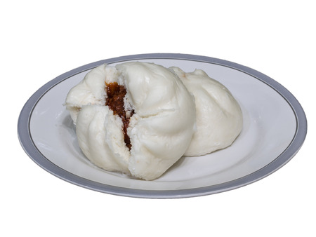 A pair of Chinese bun on white plate lay on black marble tableの写真素材