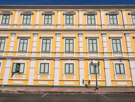 Yellow wall of Ministry of Defense of Thailand under blue sky, Bangkokの写真素材