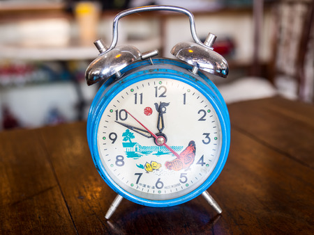 Old alarm clock on wood table