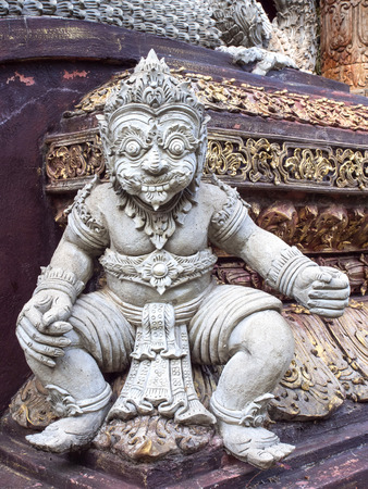 Delicate little giant sculpture at base of church of Wat Phra That Pha Ngao in Chiangrai, Thailandの写真素材