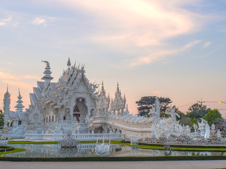 Delicate Thai art in White temple in evening skyの写真素材