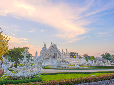 Delicate Thai art in White temple in evening skyの写真素材