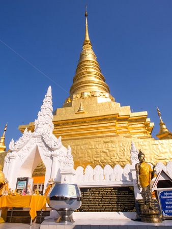 Northern Thai art Golden pagoda in Thailand under blue skyの写真素材