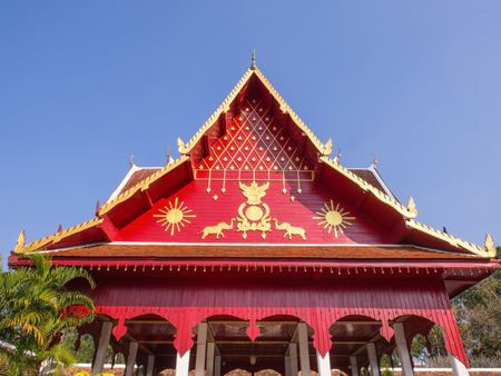 Northern Thai art roof in Thai temple under blue skyの写真素材