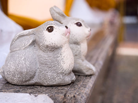 Small rabbit toy around Thai pagoda show respect in cultureの写真素材