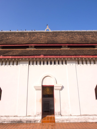 Northern Thai art of roof top of temple church in Thailand under blue skyの写真素材