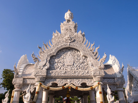 Roof and door arch Thai art delicate architecture of City Pillar Shrine in Nan, Thailandの写真素材