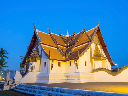 Main church of Wat Phu Mintr is very outstanding Northern style Thai art under twilight period skyの写真素材