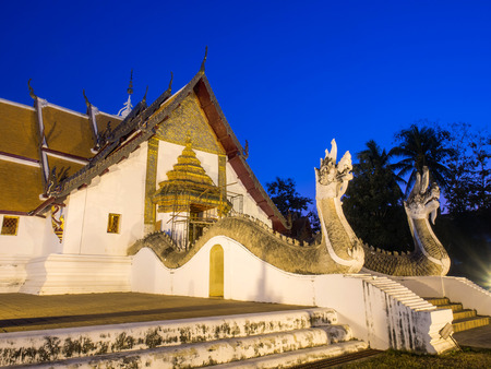 Main church of Wat Phu Mintr is very outstanding Northern style Thai art under twilight period sky under main entrance door constructionの写真素材