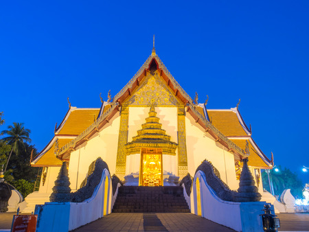 Main church of Wat Phu Mintr is very outstanding Northern style Thai art under twilight period skyの写真素材