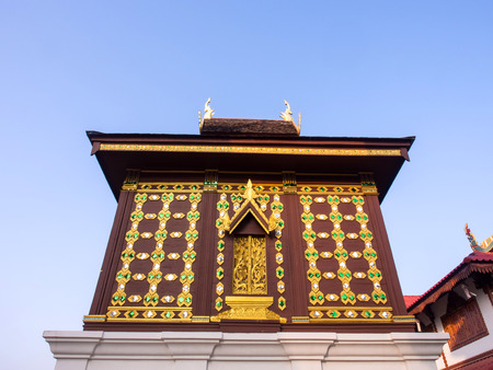 Church of Buddist book in unique Northern style Thai art under blue skyの写真素材