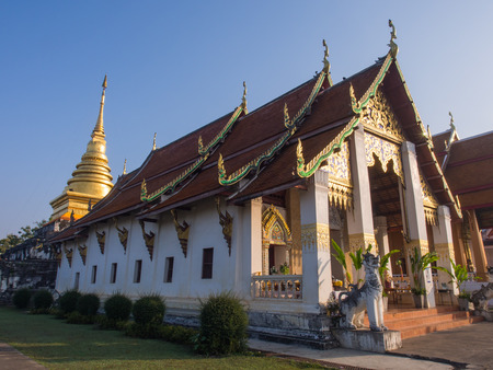 Church of Northern stlye Thai art in Nan, Thailand under blue skyの写真素材