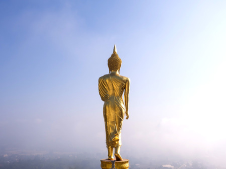 Walking large golden buddha statue is viewpoint of Nan, Thailandの写真素材