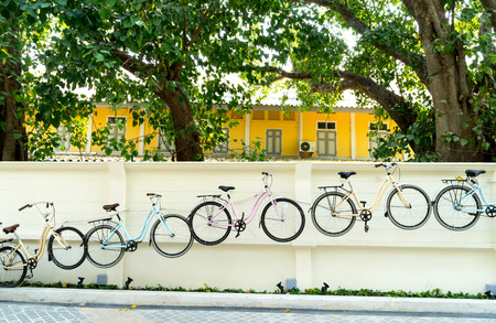 Bicycles decorated on white wall in Bangkokの写真素材