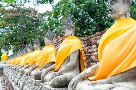 Old historic cement buddha statues along corridor of Thai temple in Ayuddhaya, Thailandの写真素材