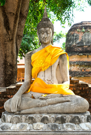 Old historic cement buddha statues along corridor of Thai temple in Ayuddhaya, Thailandの写真素材
