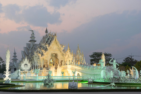 White temple with evening sky is unique beautiful Thai art in Chiangraiの写真素材