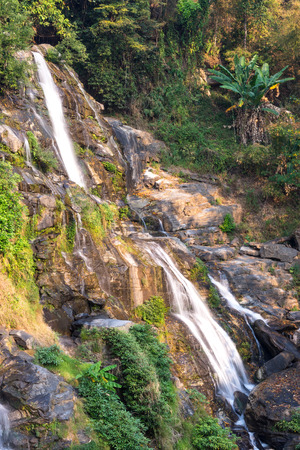 Waterfall with splashing water in forest in Thailandの写真素材