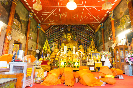 CHIANGMAI, THAILAND - MARCH 14: Group of monks in church of Wat Phra That Doi Suthep do respect to golden meditated buddha statue in Chiangmai, Thailand, was taken on March 14, 2015.のeditorial素材