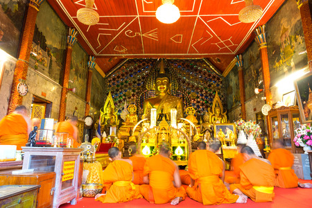 CHIANGMAI, THAILAND - MARCH 14: Group of monks in church of Wat Phra That Doi Suthep do respect to golden meditated buddha statue in Chiangmai, Thailand, was taken on March 14, 2015.のeditorial素材