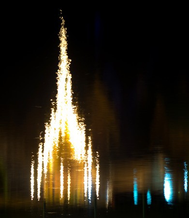 Reflection of Thai pagoda on dark black waterの写真素材