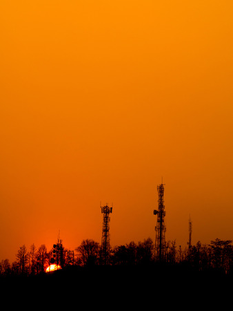 Sunset over urban mountain on orange evening skyの写真素材