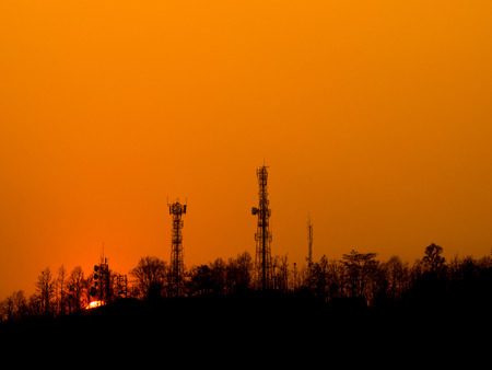 Sunset over urban mountain on orange evening skyの写真素材