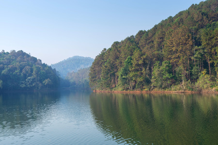 Pang Oung is pretty and serene lake in a valley glittering with sunlight in morning sunrise surrounded by mountainsの写真素材