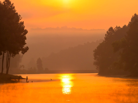 Pang Oung is pretty and serene lake in a valley glittering with sunlight in morning sunrise surrounded by mountainsの写真素材