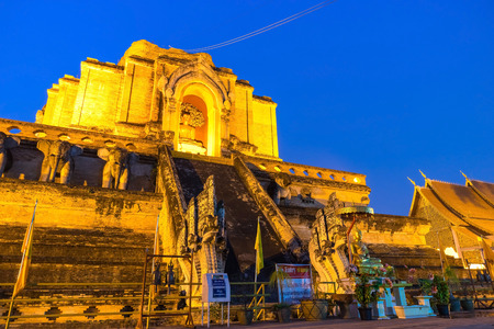 Ruined famous large buddhist Northern Thai art pagoda of Wat Jedi Luang in twilight evening period in Chiangmai, Thailand. Thai letters mean for public announcement, no any trademarks or copyrights.の写真素材