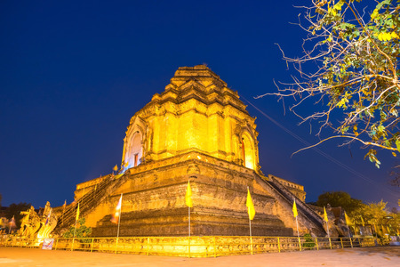 Ruined famous large buddhist Northern Thai art pagoda of Wat Jedi Luang in twilight evening period in Chiangmai, Thailandの写真素材