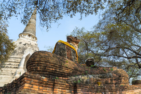 Historic destroyed temple, Ayuddhaya, old brick pagoda and Buddhism church under blue bright sky in summer, Thailandの写真素材