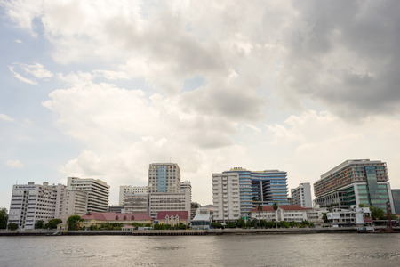 Buildings of Siriraj hospital the first hospital in Thailand along Chaophraya river under cloudy skyのeditorial素材