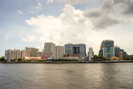 Buildings of Siriraj hospital the first hospital in Thailand along Chaophraya river under cloudy skyのeditorial素材