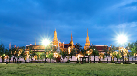 Outside beautiful landmark view of The Grand Emerald temple in Bangkok, Thailand with night light view and street light flareの写真素材